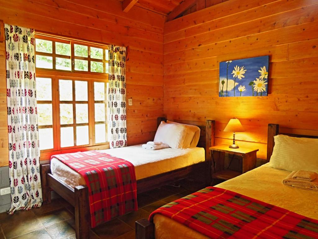 Postel nebo postele na pokoji v ubytování Rancho Amalia