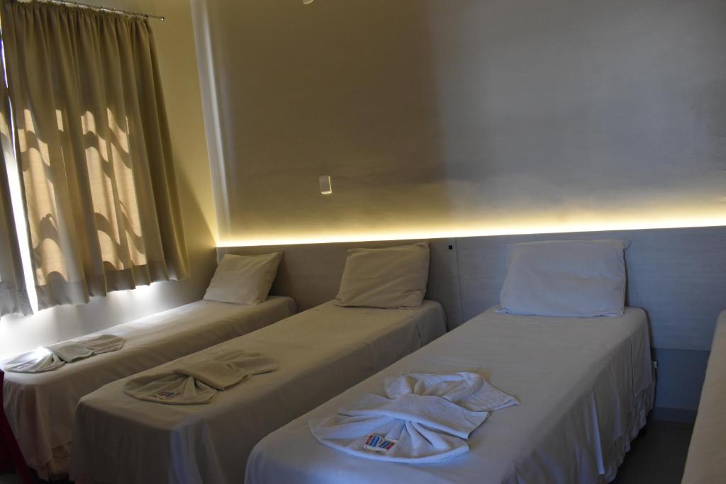 Postel nebo postele na pokoji v ubytování Hotel Ipiranga Maringa