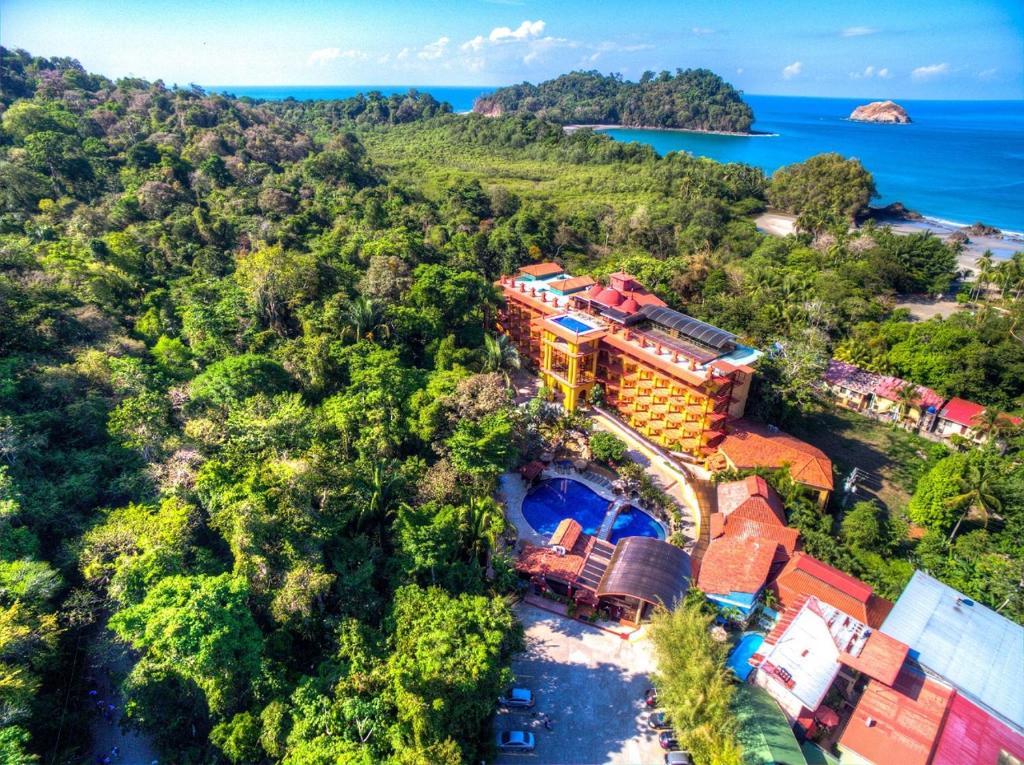 an aerial view of a house on a hill next to the ocean at Hotel San Bada Resort & Spa in Manuel Antonio