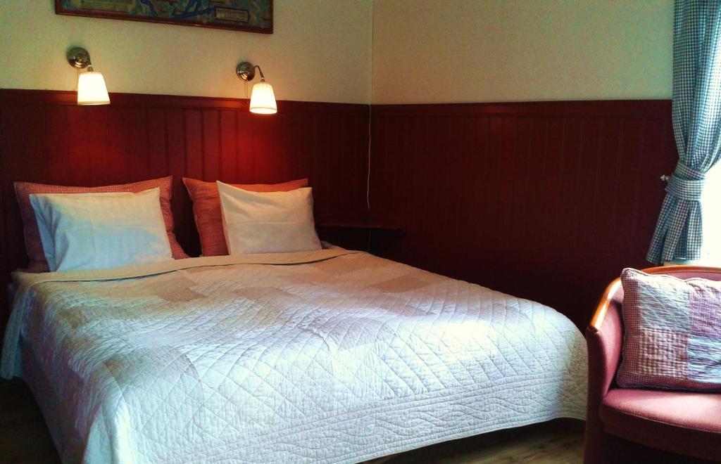 Postel nebo postele na pokoji v ubytování Lugnet Malung Hotell