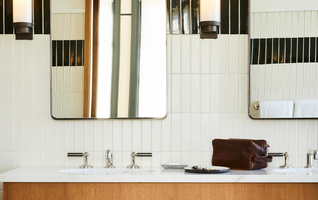 a bathroom with two sinks and a mirror at Shinola Hotel in Detroit