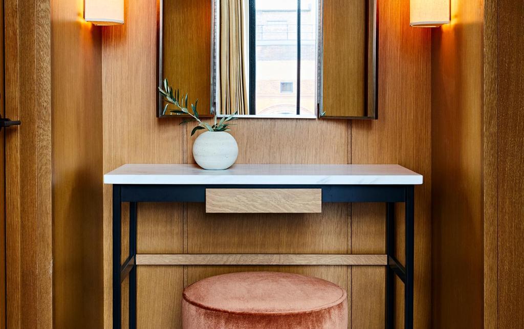 a bathroom with a counter with a vase on it at Shinola Hotel in Detroit