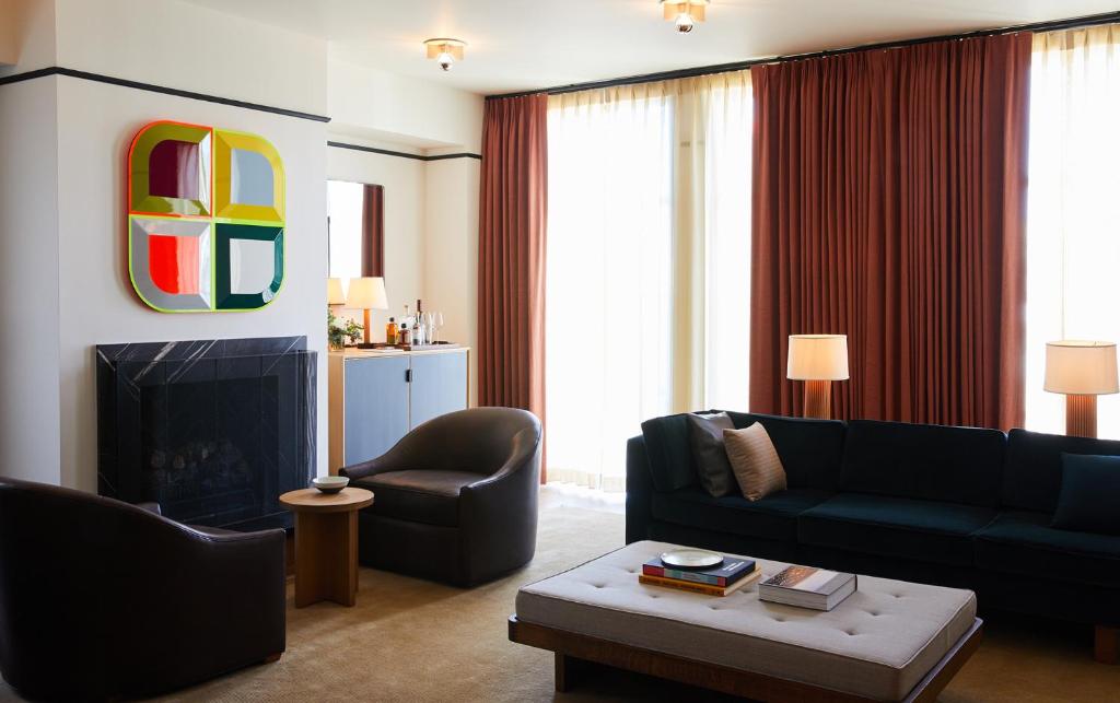 a living room with a couch and a fireplace at Shinola Hotel in Detroit
