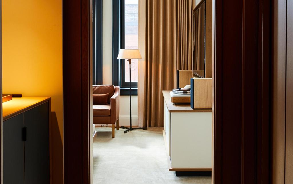 a room with a desk and a chair and a window at Shinola Hotel in Detroit