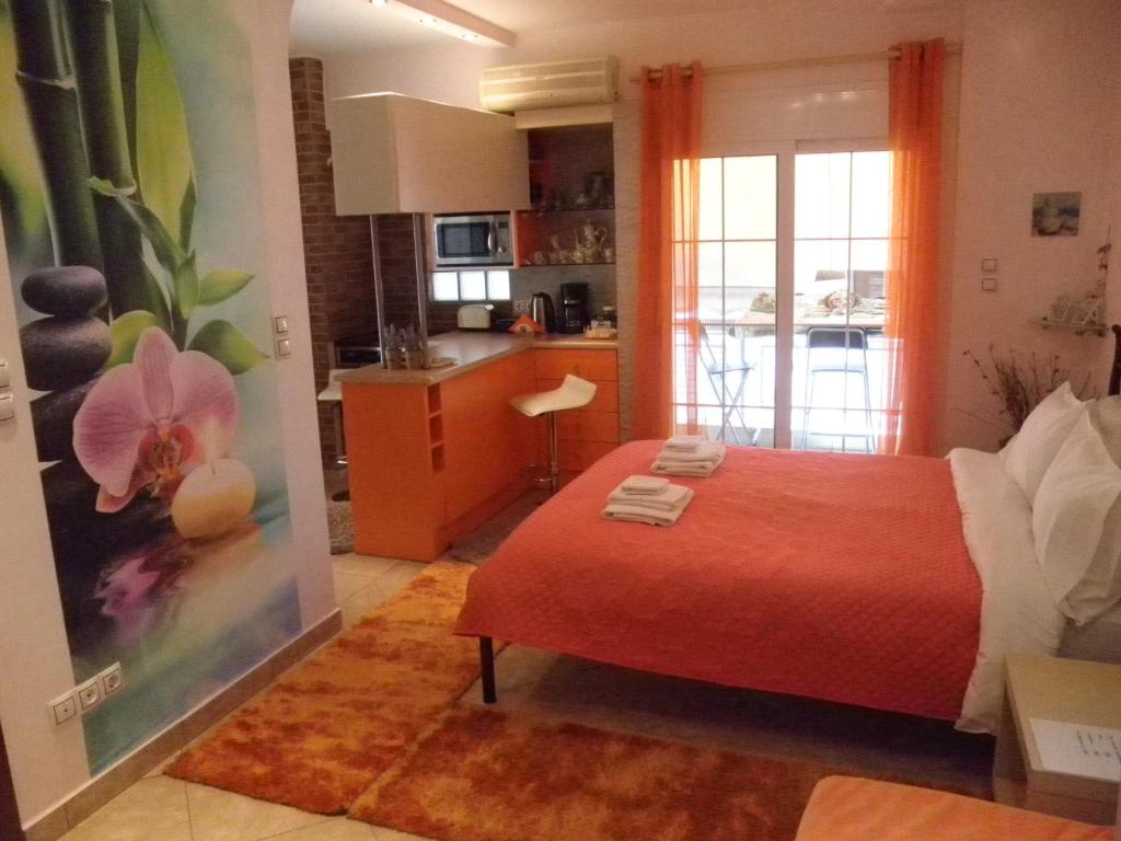 Cet appartement comprend une chambre avec un lit rouge et une cuisine. dans l'établissement Dreaming Stay, à Athènes