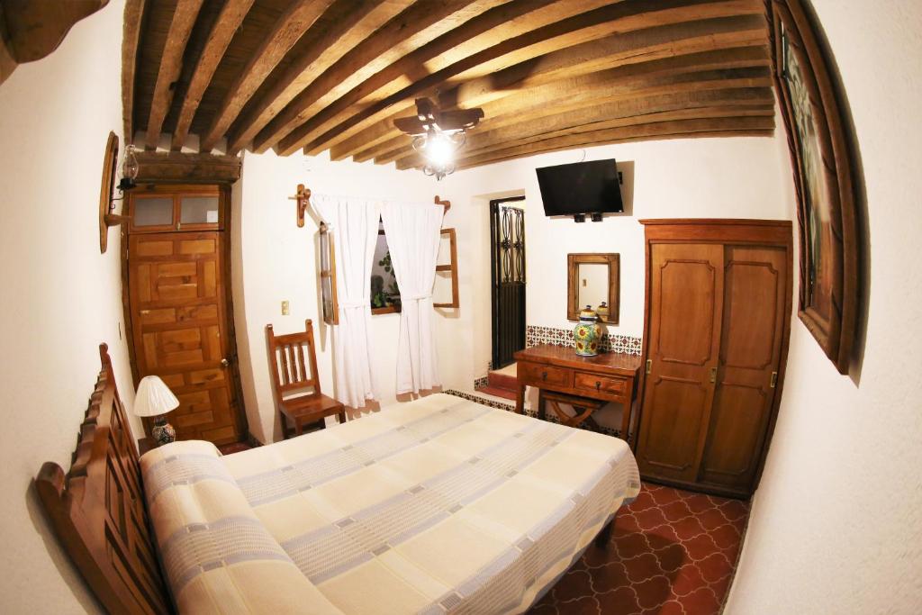 Postel nebo postele na pokoji v ubytování Hotel Mesón del Rosario