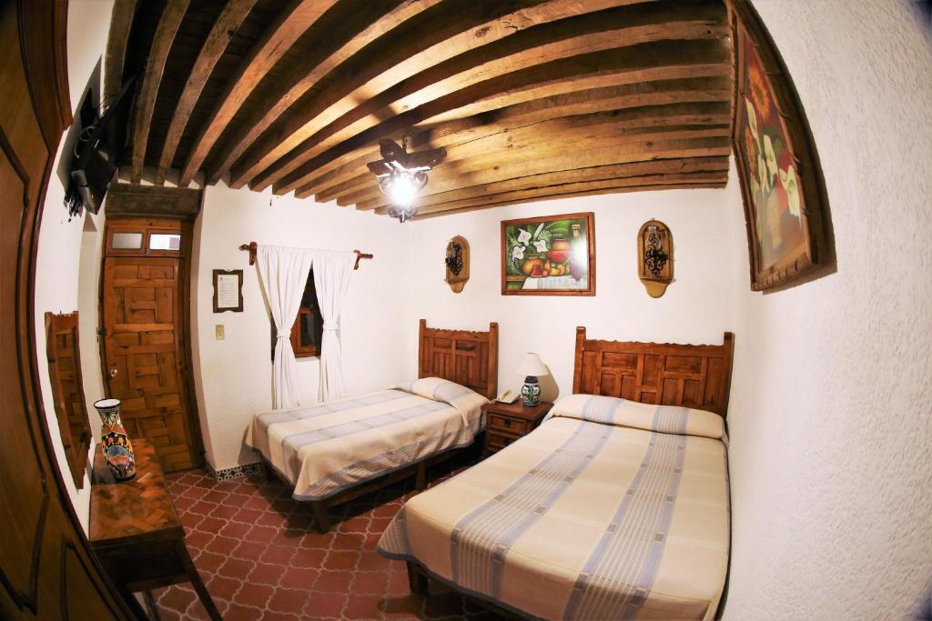 Postel nebo postele na pokoji v ubytování Hotel Mesón del Rosario