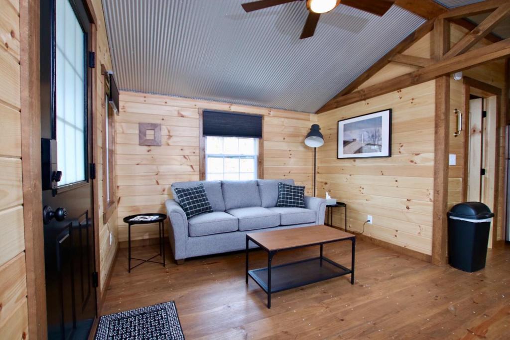 a living room with a couch and a table at The Cayo Cabin, Millersburg Ohio in Millersburg