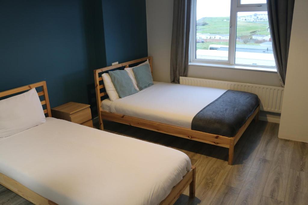 Postel nebo postele na pokoji v ubytování Rougey Lodge Hostel