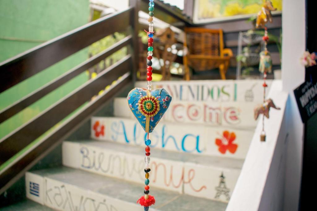 a toy heart hanging from a string next to stairs at Mahalo Hostel in Abraão