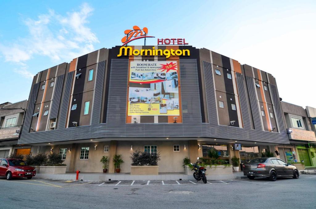 a hotel with a sign on the front of a building at Hotel Mornington Bukit Permata Lumut in Lumut
