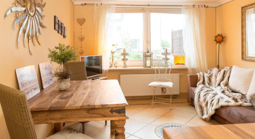 シャルボイツにあるAltes Strandhus Kl.App Casa Ostseeのリビングルーム(木製テーブル、ソファ付)