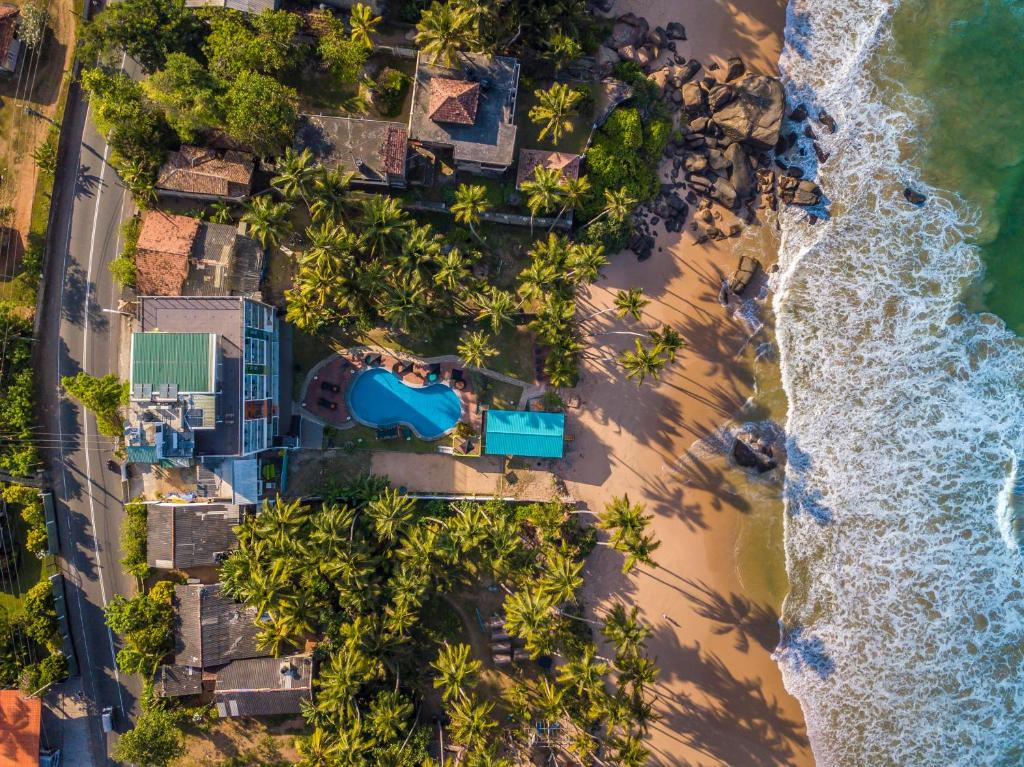 an overhead view of a beach with palm trees at Hotel J Ambalangoda in Ambalangoda