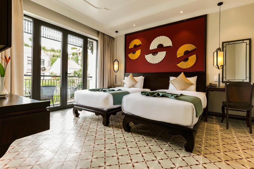 Llit o llits en una habitació de Laluna Hoi An Riverside Hotel & Spa