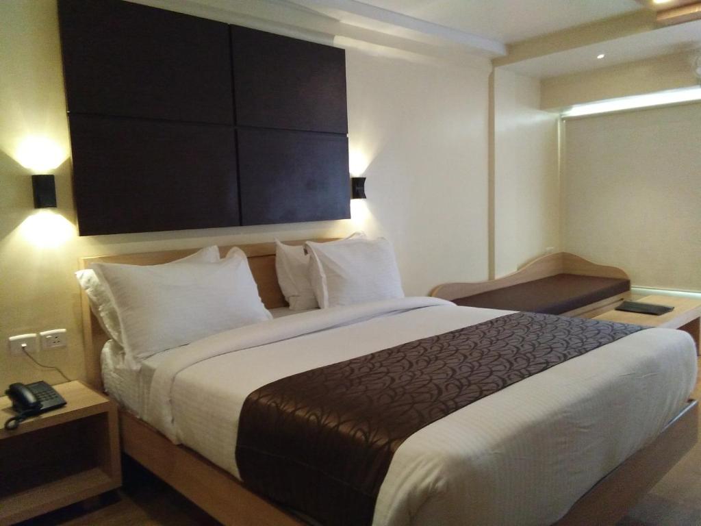 a bedroom with a large bed in a hotel room at Darshan Resorts Pvt ltd in Ooty