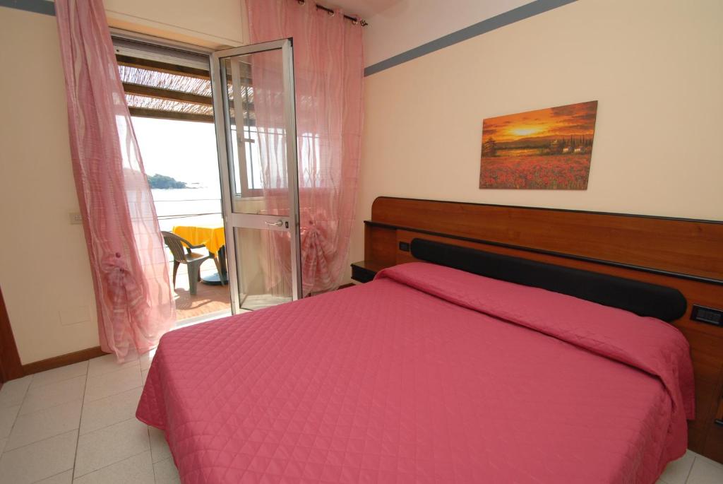 Postel nebo postele na pokoji v ubytování Hotel Baia Del Sorriso