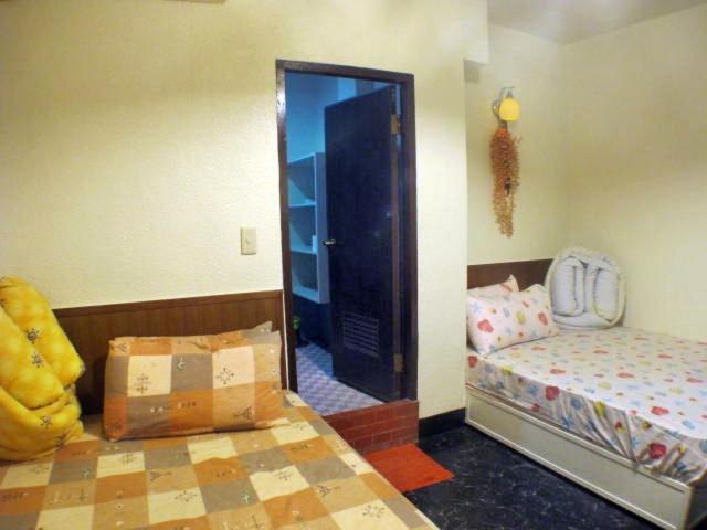 Postel nebo postele na pokoji v ubytování Ku Shan Yuan Hotel