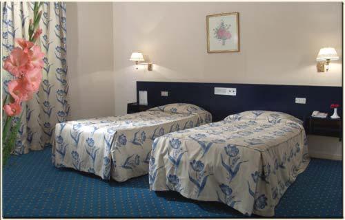 Postel nebo postele na pokoji v ubytování Hotel Concorde Dokki