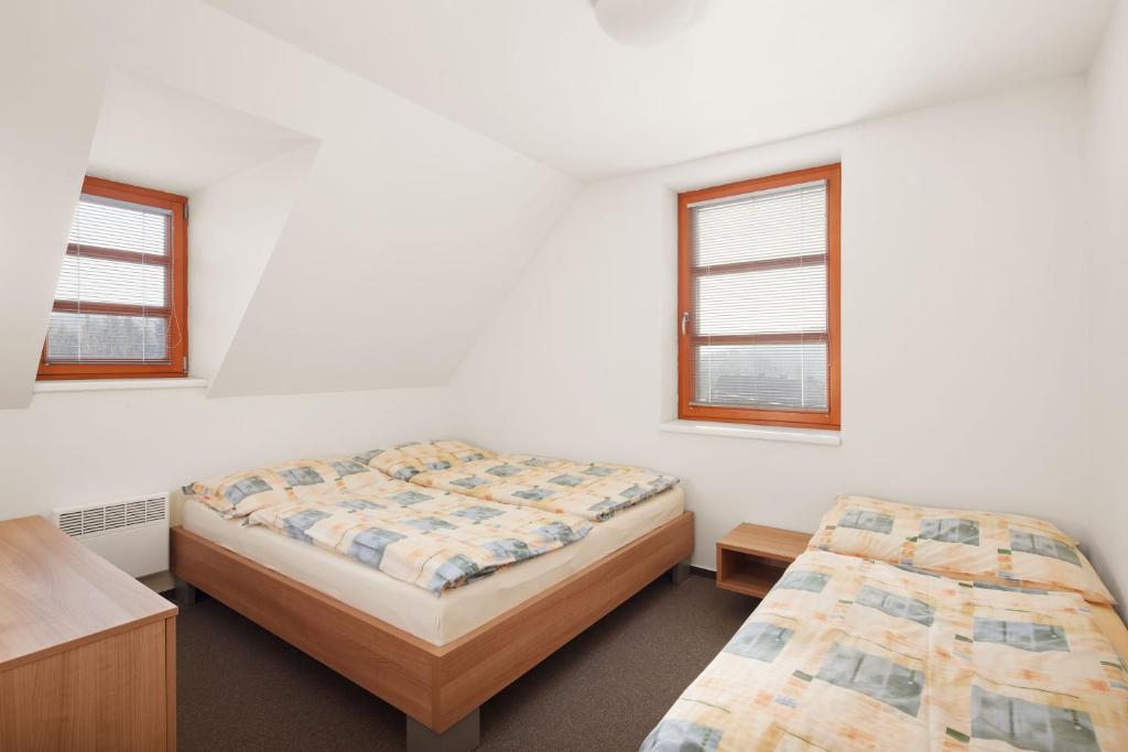 Postel nebo postele na pokoji v ubytování Wellness Hotel Říčky