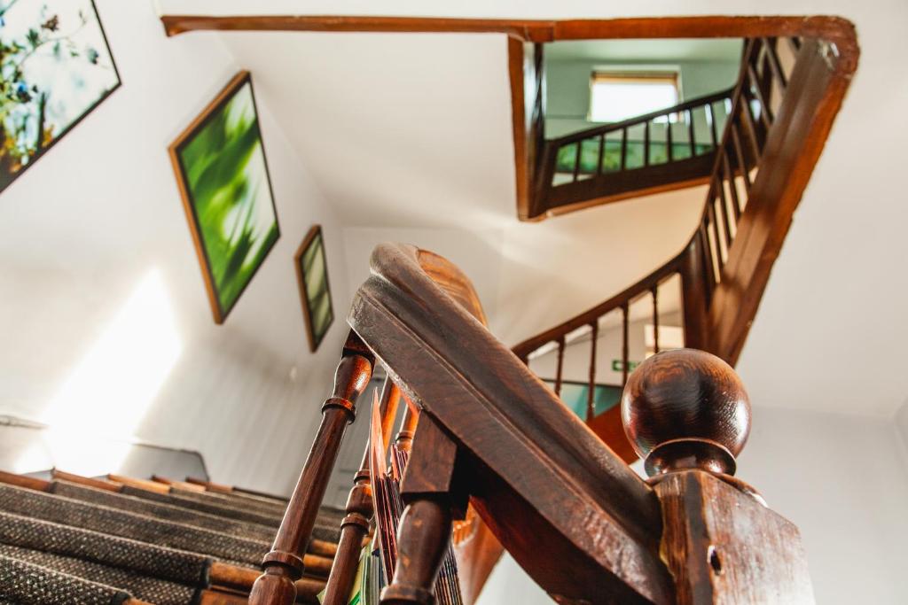 a staircase with a wooden rocking chair and stairs at Hotel Mirabeau in Tours