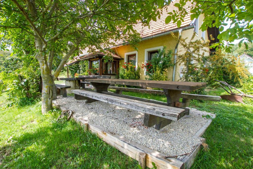 a picnic bench in front of a house at Holiday Home Juričko with private Sauna in Bizeljsko
