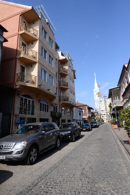 a street with cars parked on the side of a building at Hotel Aristocrat Batumi in Batumi