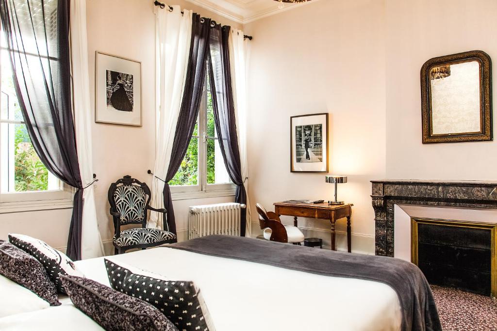 - une chambre avec un lit et une cheminée dans l'établissement Hotel Mirabeau, à Tours