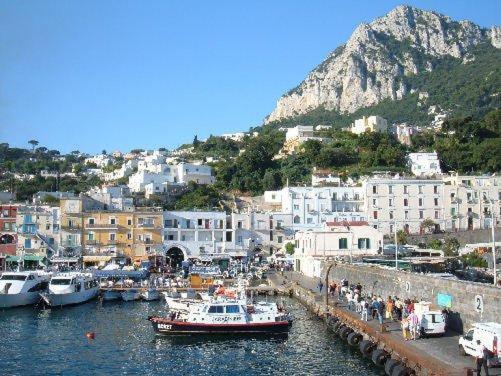 a group of boats are docked in a harbor at Soleluna in Capri