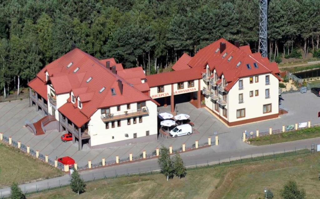 an aerial view of a large house with red roofs at Pensjonat nad Zalewem in Stare Miasto