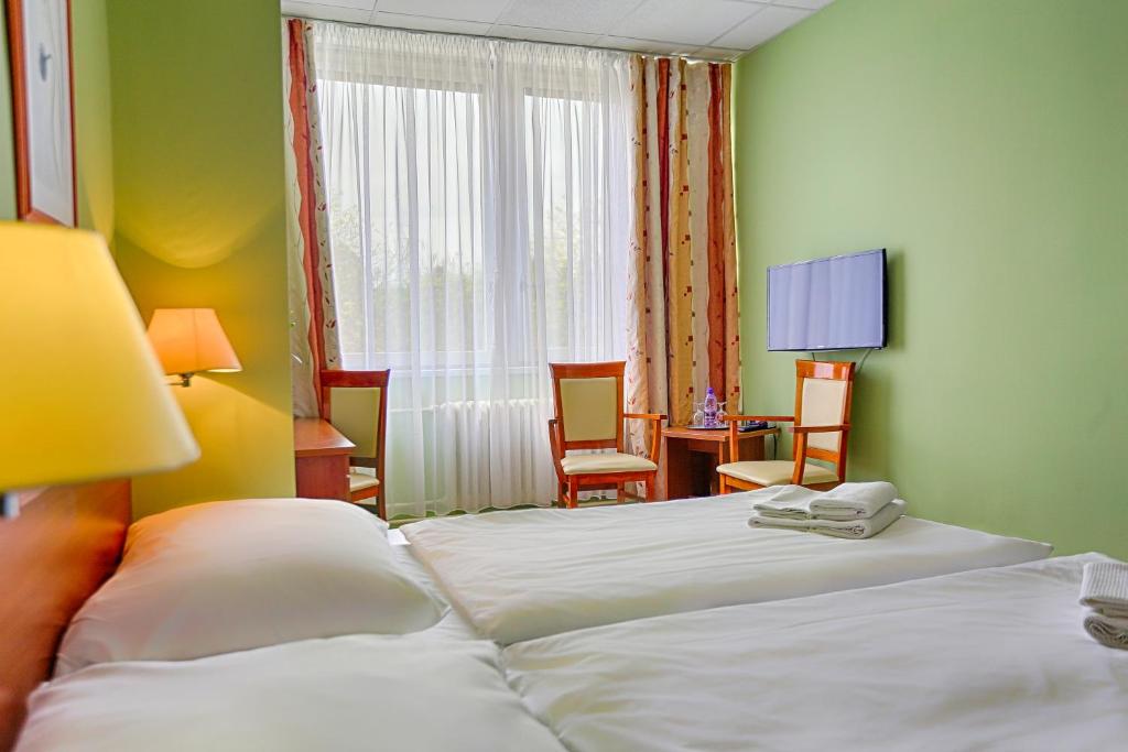 Postel nebo postele na pokoji v ubytování Ensana Spa Smrdáky