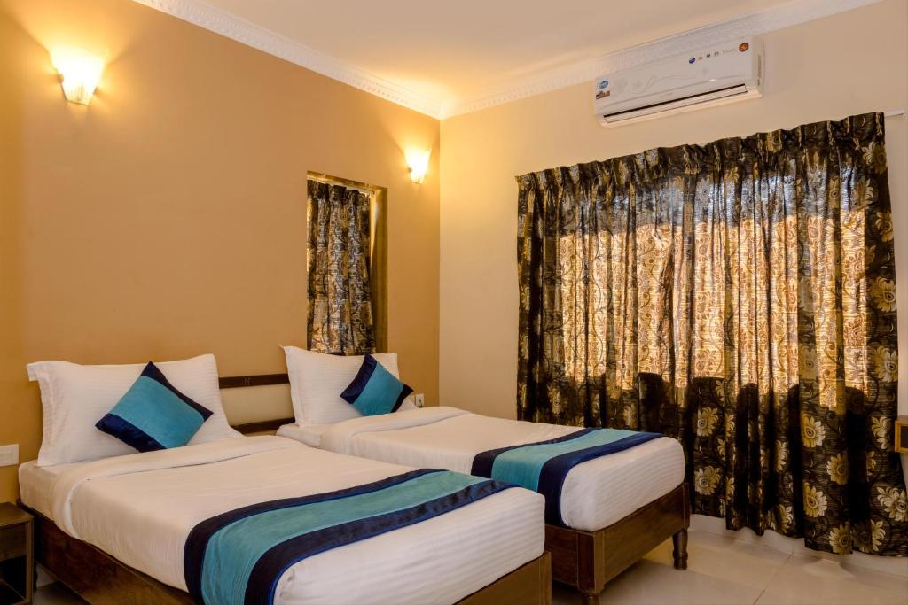 Postel nebo postele na pokoji v ubytování Rendezvous Beach Resort Panjim