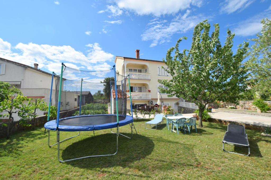 a trampoline in the yard of a house at Apartment Danica in Malinska