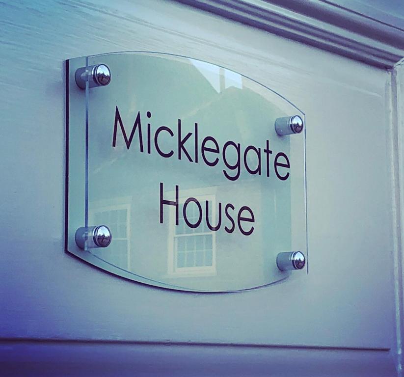 a mirror on a wall with the words mickeeper house at Micklegate House in Selby