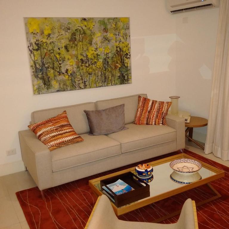 a living room with a couch and a table at Ocean Flat in Rio de Janeiro