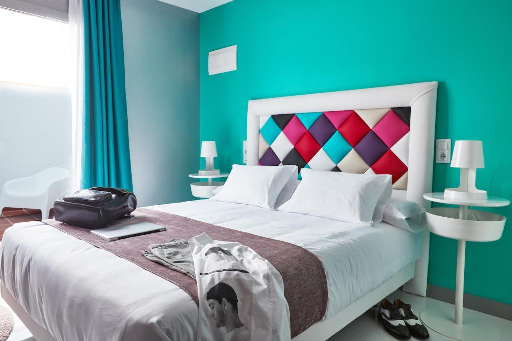 a hotel room with a bed, desk, and nightstand at Hotel Freedom in Madrid
