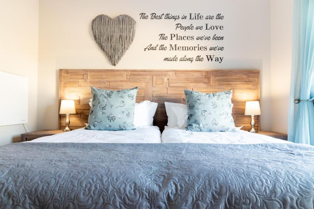 a bedroom with a bed with a heart above it at Memories Self-Catering at 5 on Smith in Oudtshoorn