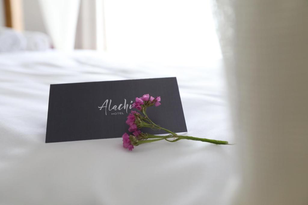 A bed or beds in a room at Alachi Hotel