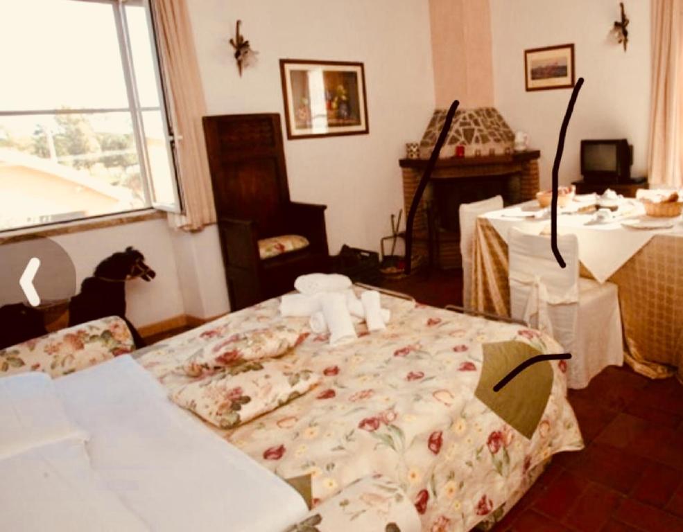 a bedroom with a bed in a room with a table at AGRITURISMO NUOVA FATTORIA in Borgo Sabotino