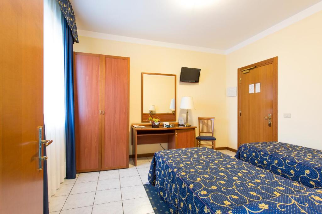 Postel nebo postele na pokoji v ubytování Hotel Ristorante Paladini