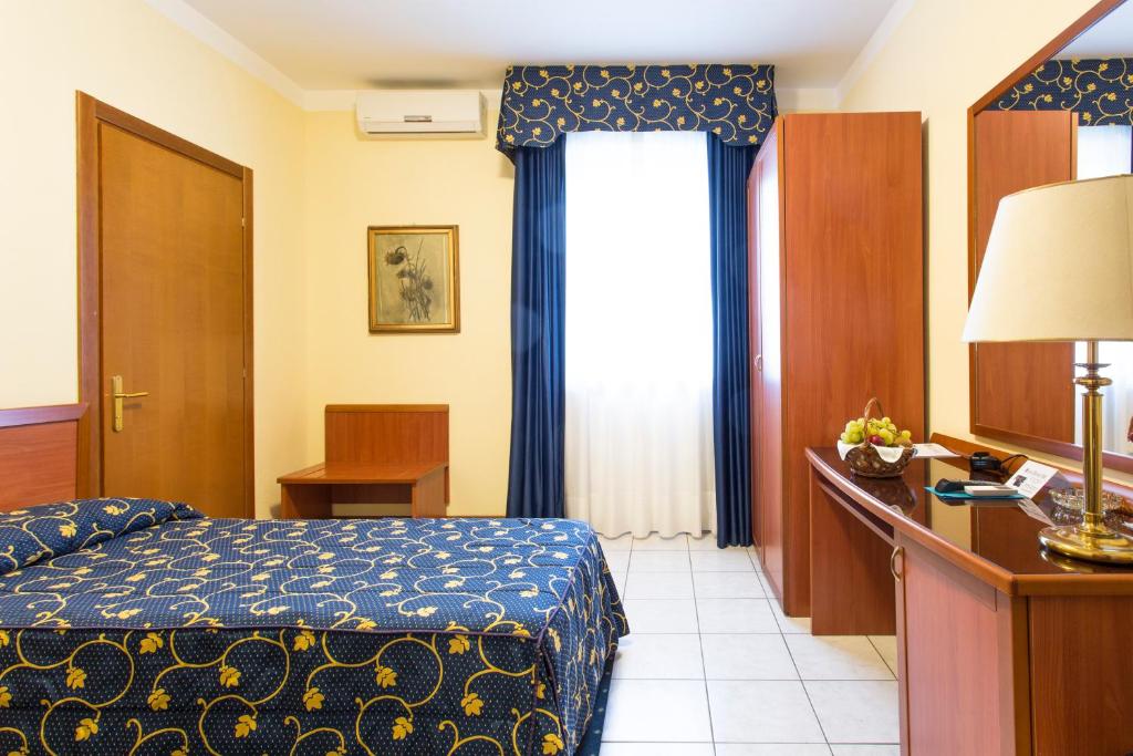 Postel nebo postele na pokoji v ubytování Hotel Ristorante Paladini