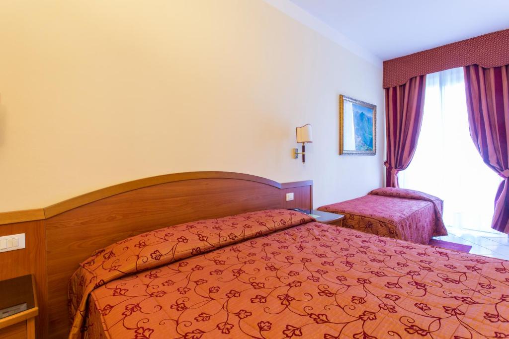 Postel nebo postele na pokoji v ubytování Hotel Ristorante Paladini