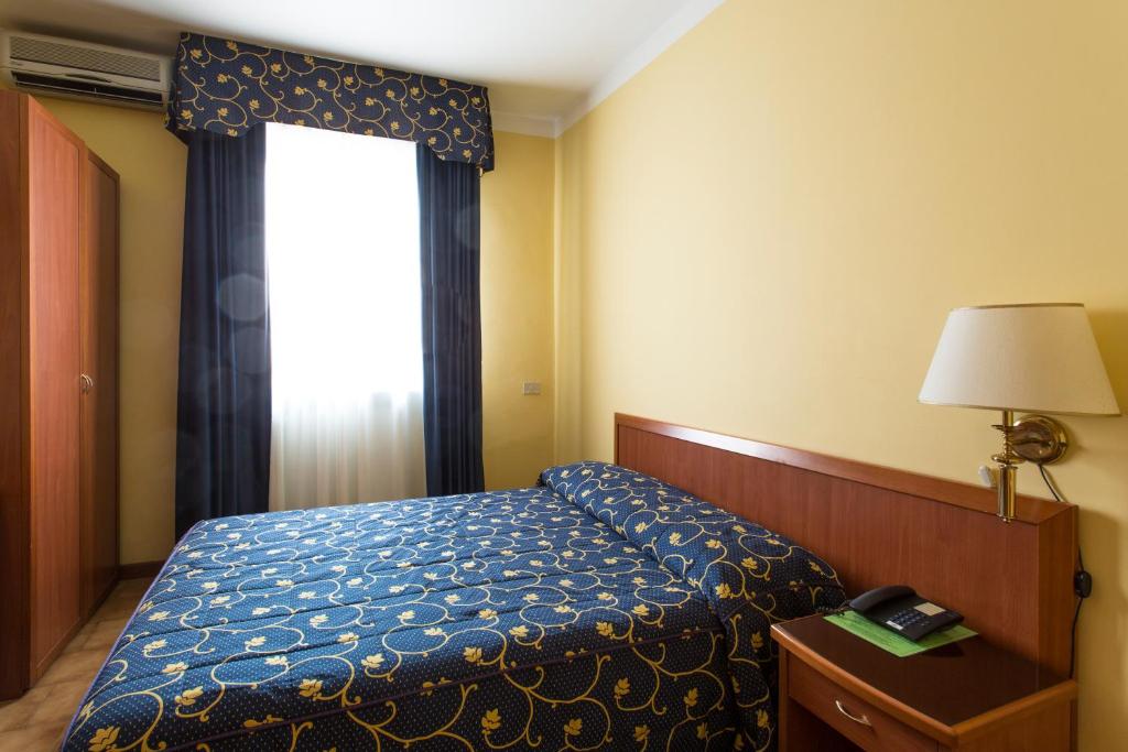 Postel nebo postele na pokoji v ubytování Hotel Ristorante Paladini