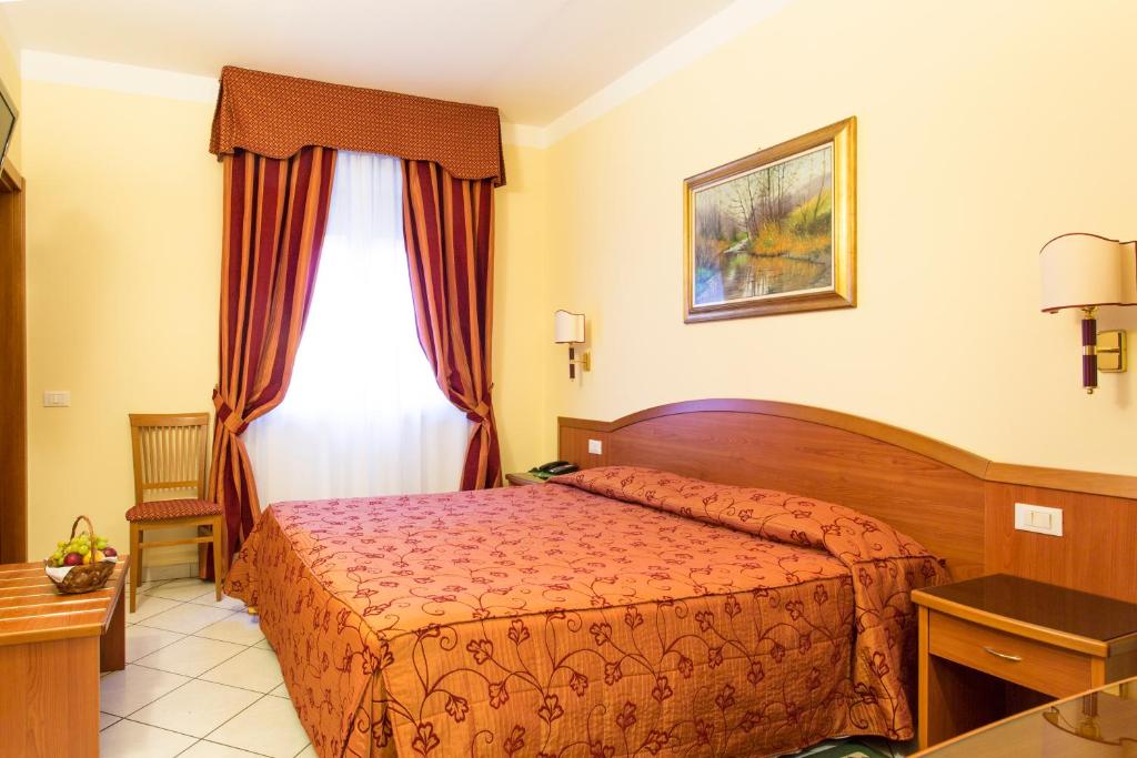 Postel nebo postele na pokoji v ubytování Hotel Ristorante Paladini
