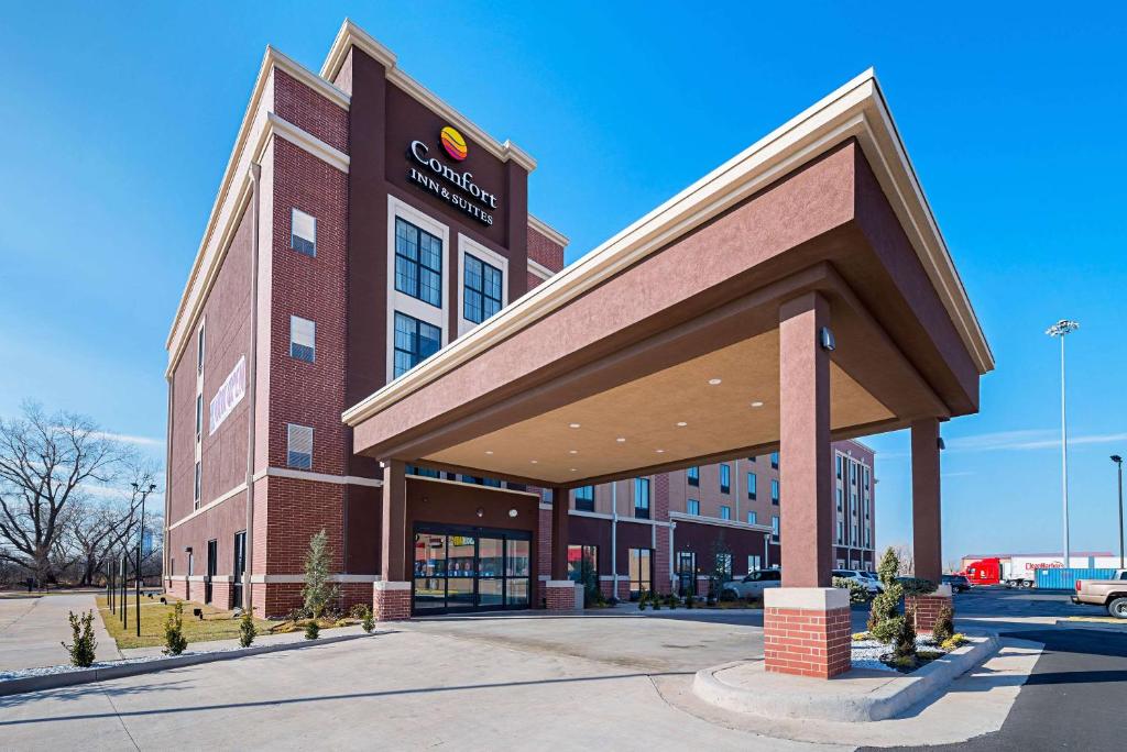 a large brick building with a sign on it at Comfort Inn & Suites Oklahoma City near Bricktown in Oklahoma City