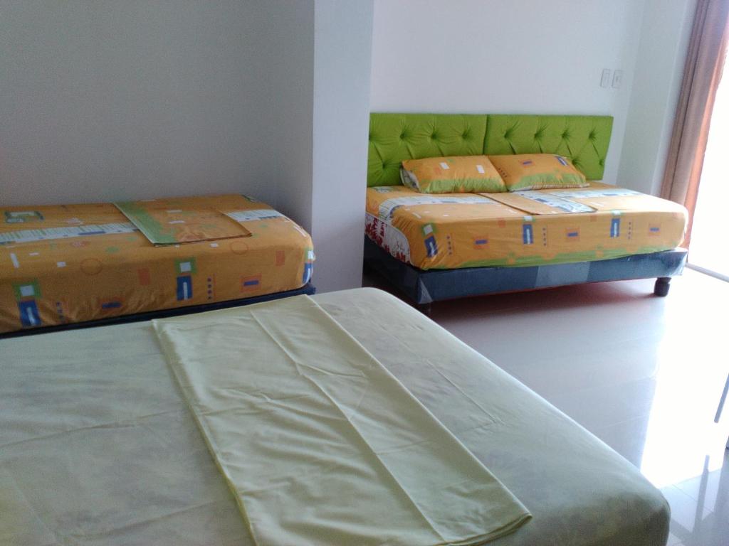 Postel nebo postele na pokoji v ubytování Hotel Almond Beach