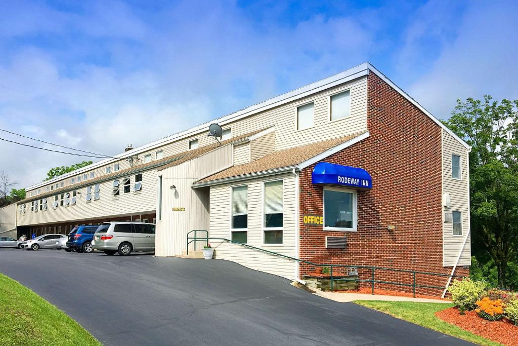 a building with a parking lot in front of it at Rodeway Inn State College - near University in State College