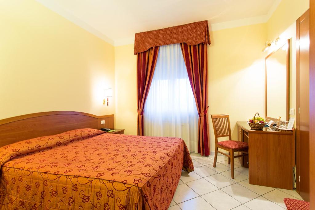 Postel nebo postele na pokoji v ubytování Hotel Ristorante Paladini