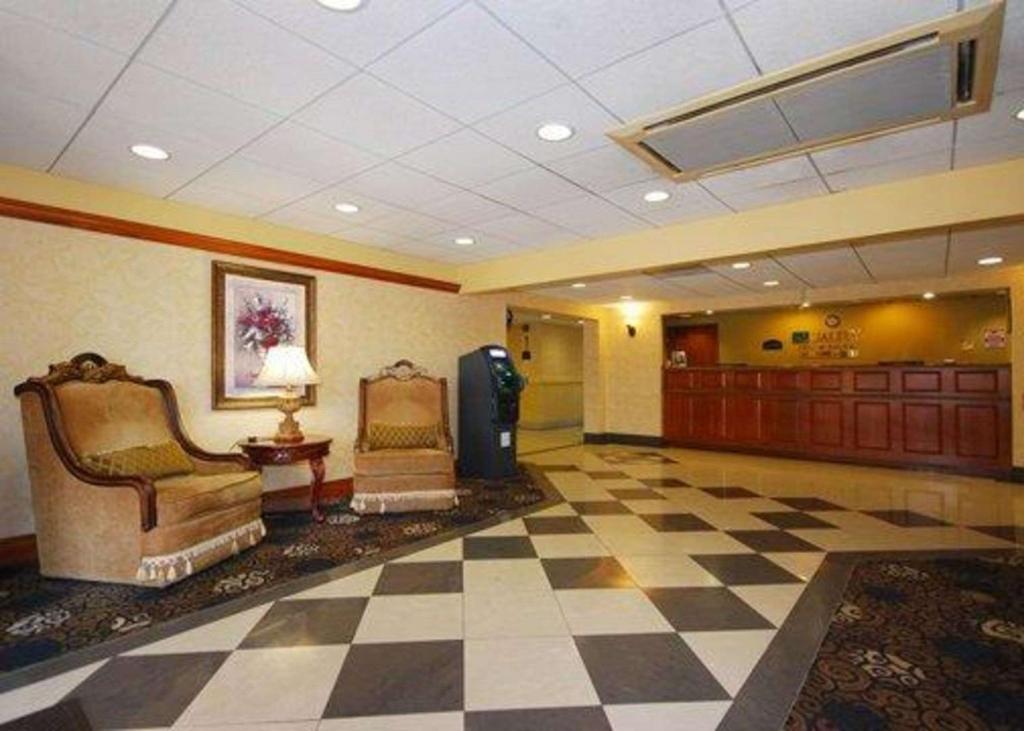 a lobby with two chairs and a checkerboard floor at Quality Inn & Suites in Bensalem