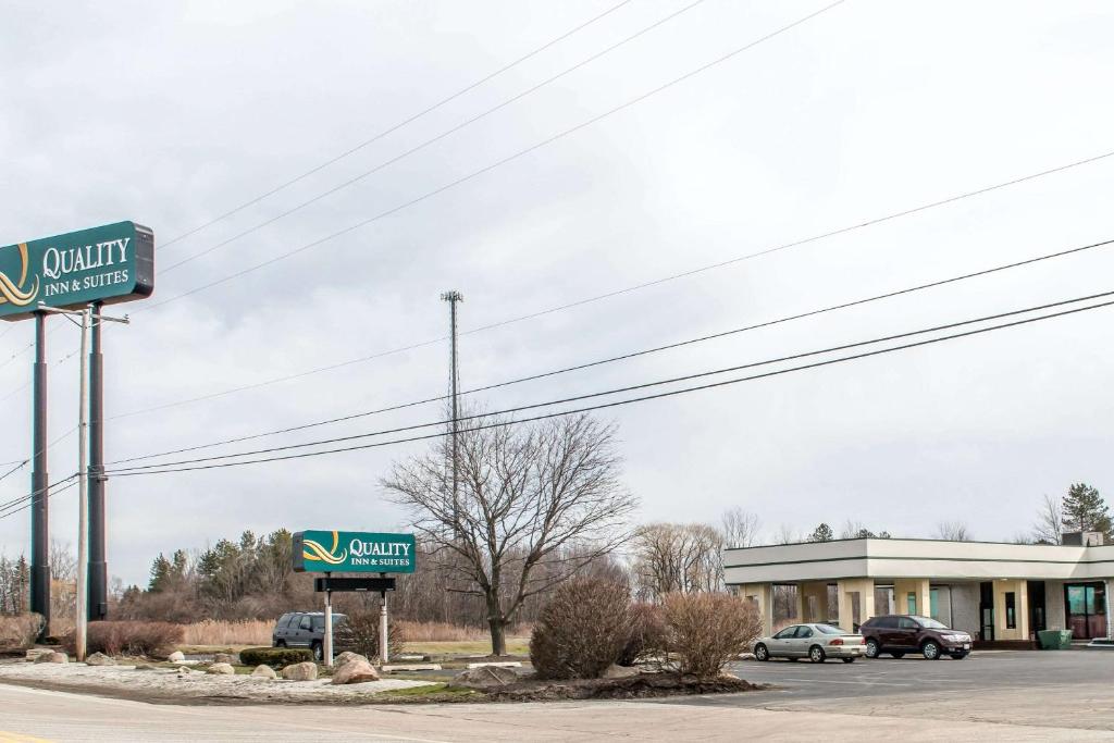 a sign for a store in a parking lot at Quality Inn & Suites Fairview in Fairview