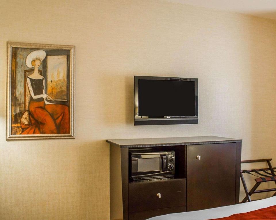 a room with a flat screen tv and a cabinet at Comfort Suites in Edinboro